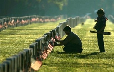 Cub Scouts place flags on graves at Long Island National Cemetery, in Farmingdale, N.Y., Saturday, May 28, 2005. The two brothers are among thousands of volunteers who place flags at the cemetery in observance of Memorial Day. (AP Photo/Ed Betz)